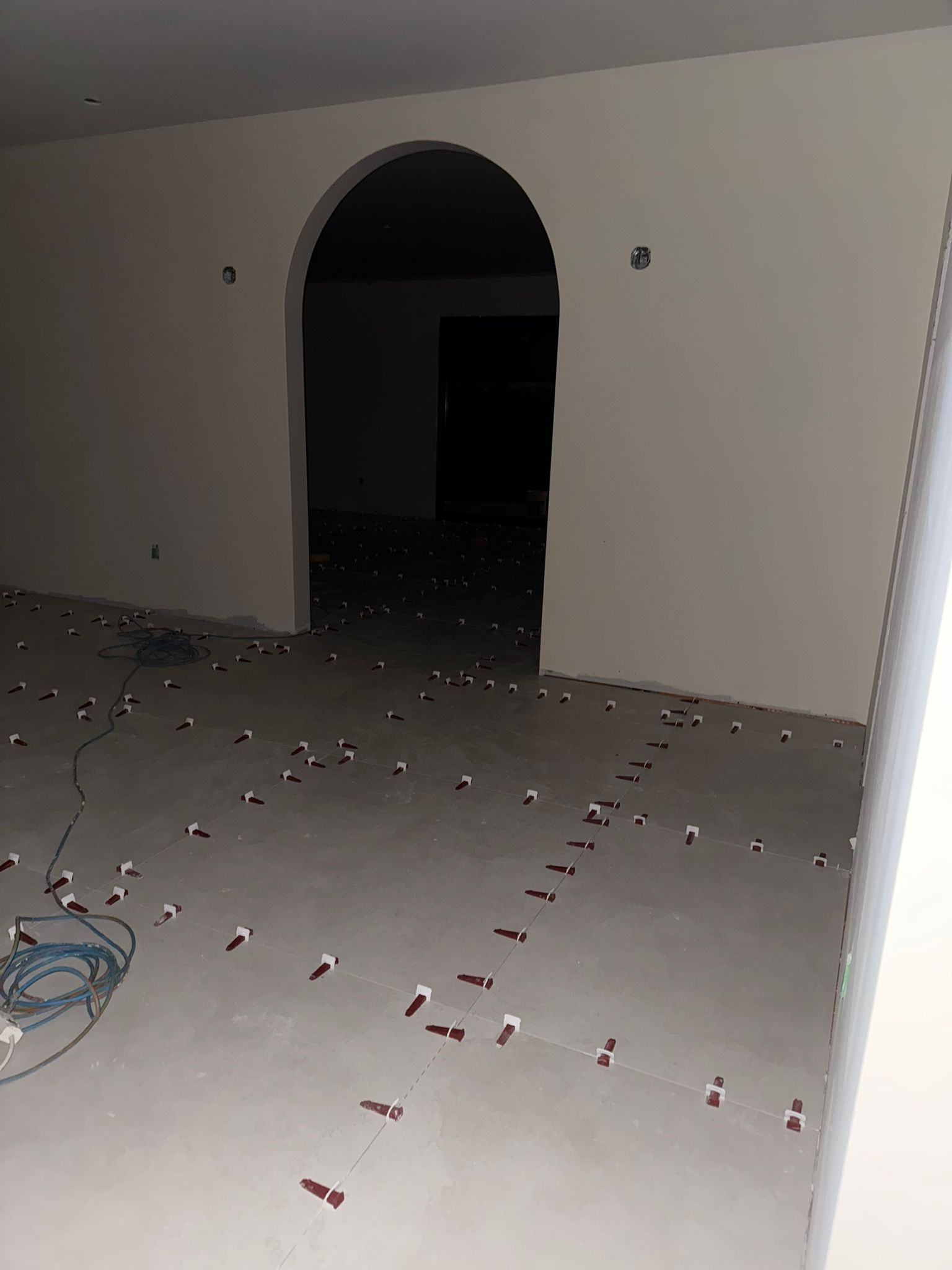 Large floor tile installation with leveling clips and layout alignment