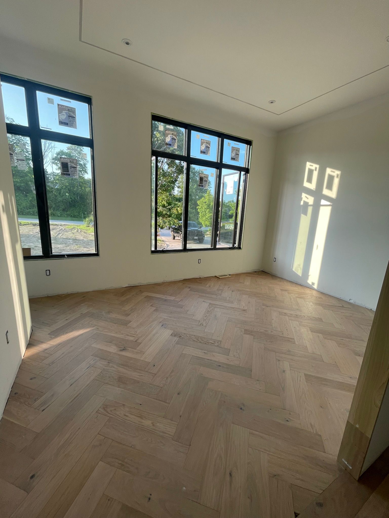Bright room with oak herringbone hardwood flooring