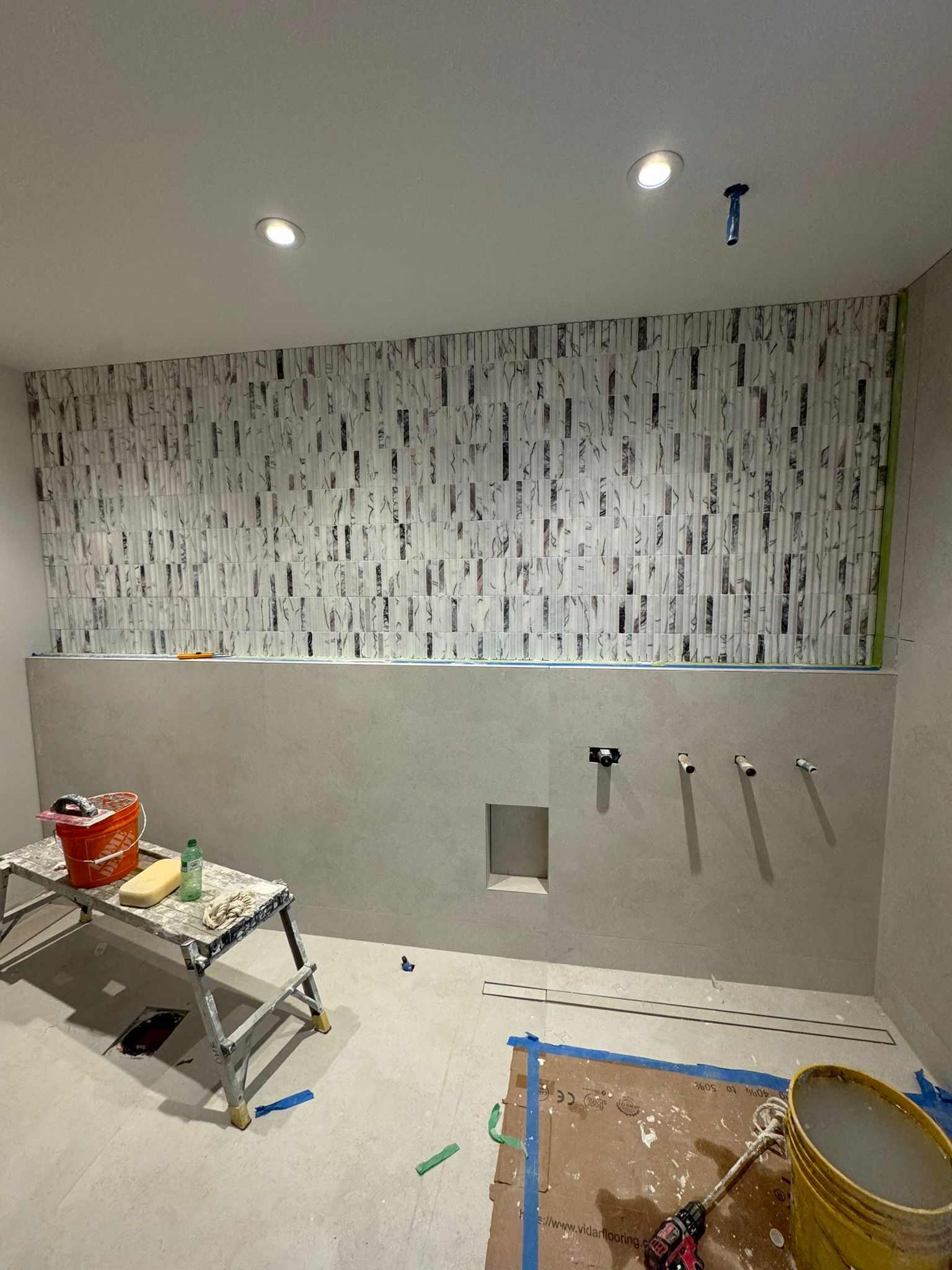 Washroom feature wall with vertical marble mosaic tile